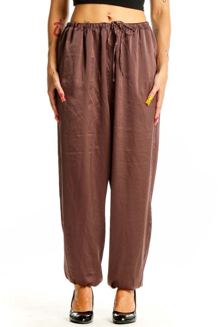 Front view of brown Uniqlo relaxed fit pants with drawstring waist