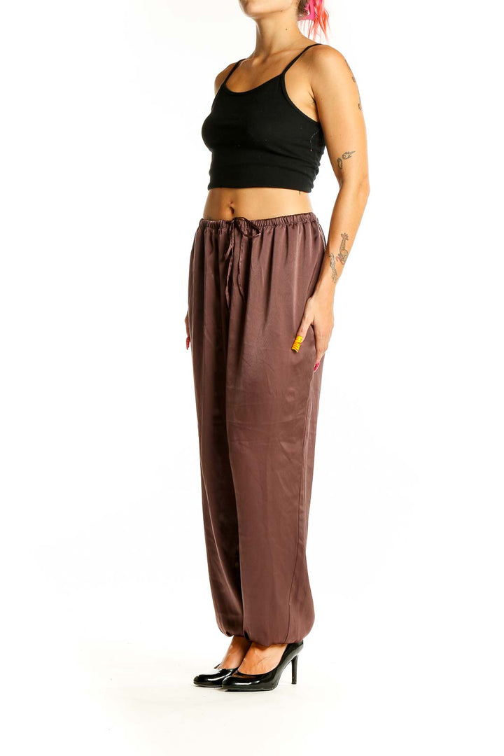 Front view of brown Uniqlo relaxed fit pants with drawstring waist