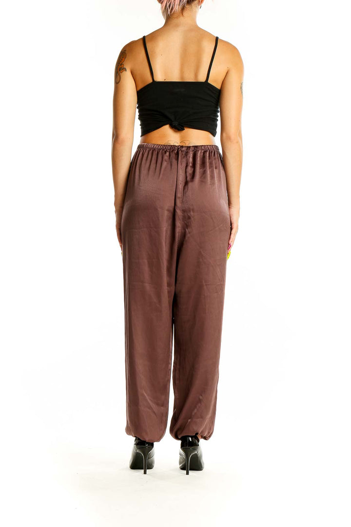 Back view of brown Uniqlo relaxed fit pants on model