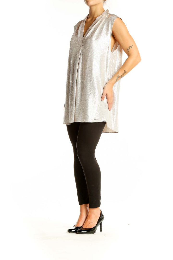 Front view of Calvin Klein silver sleeveless V-neck blouse on model