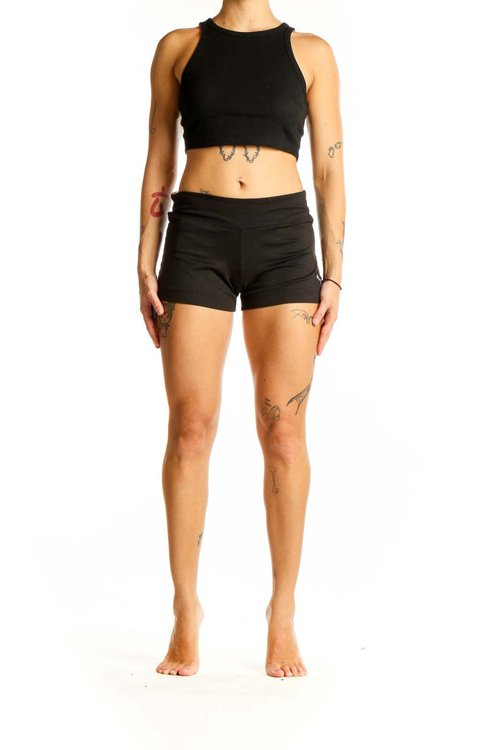 Front view of black Puma athletic shorts on model