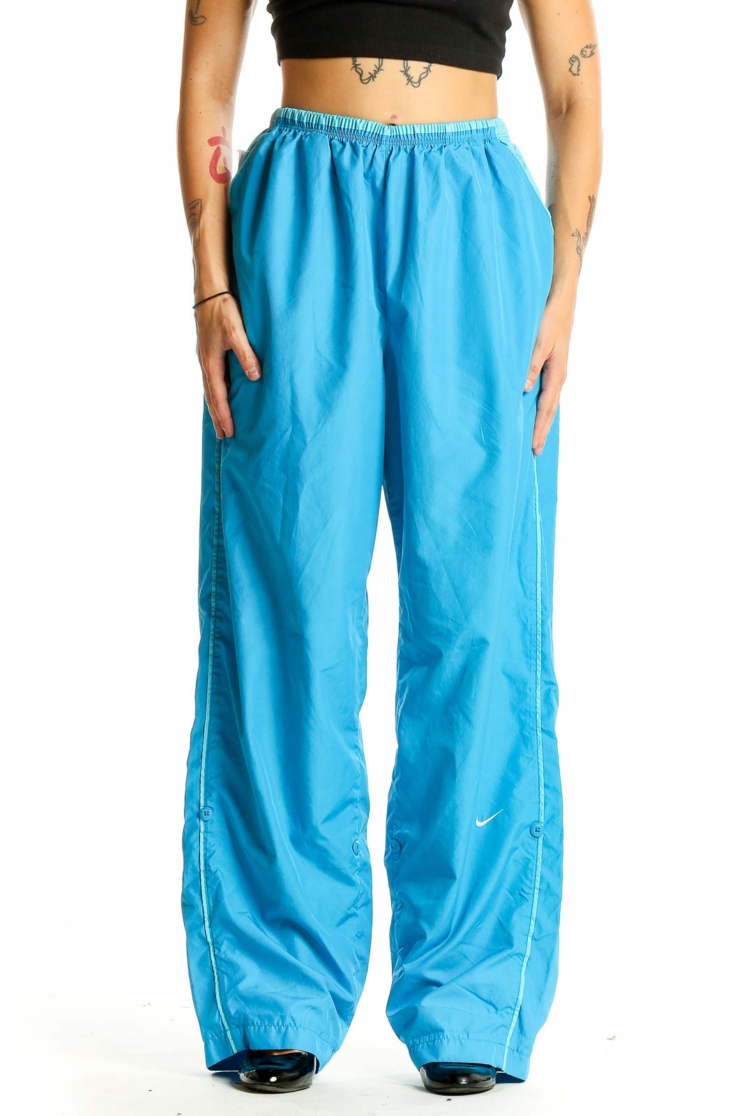 Front view of blue Nike wide-leg track pants