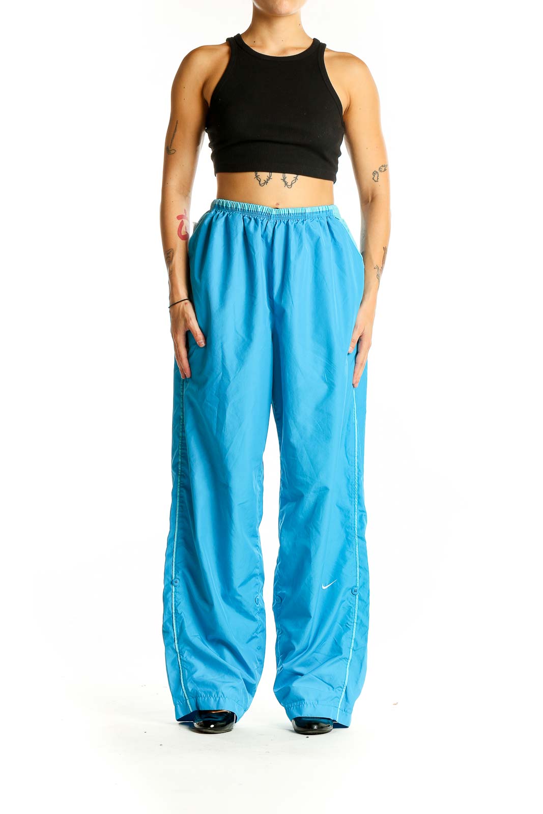 Front view of blue Nike wide-leg track pants