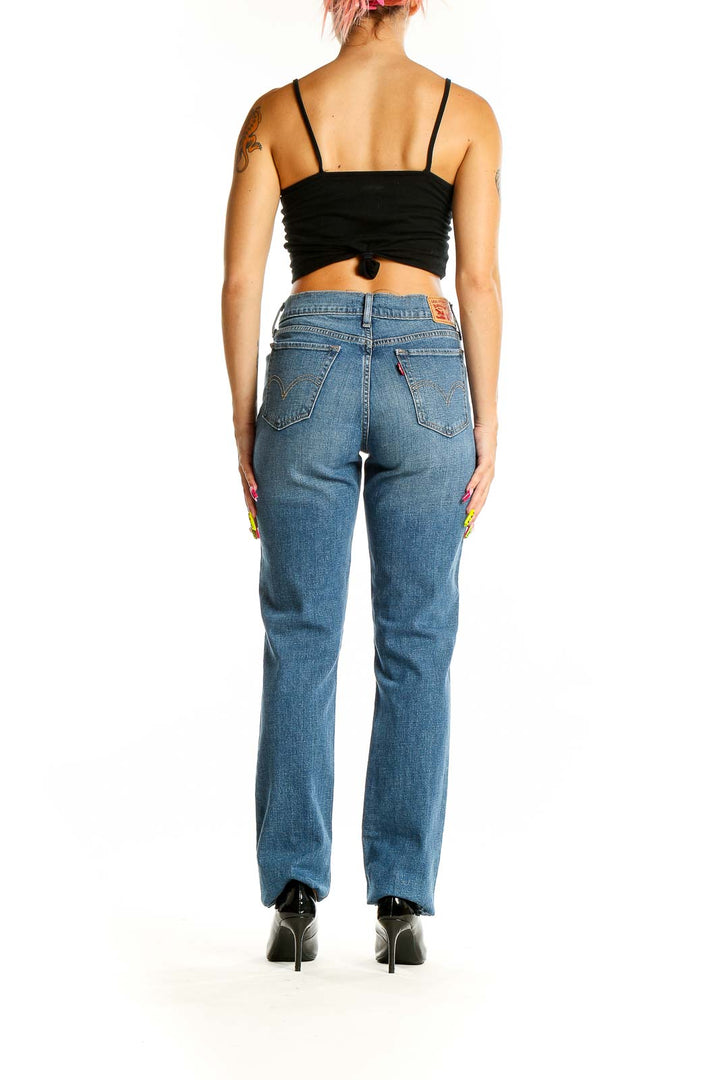 Back view of Levi's medium wash straight leg jeans on model