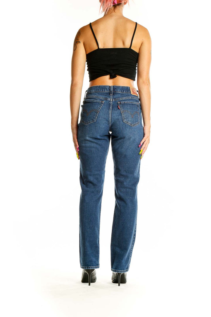 Back view of Levi's medium blue straight leg jeans on model