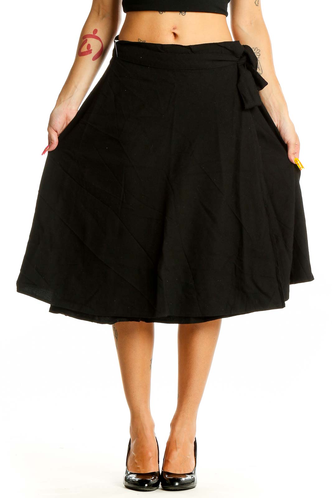 Front view of black A-line midi skirt with tie waist detail