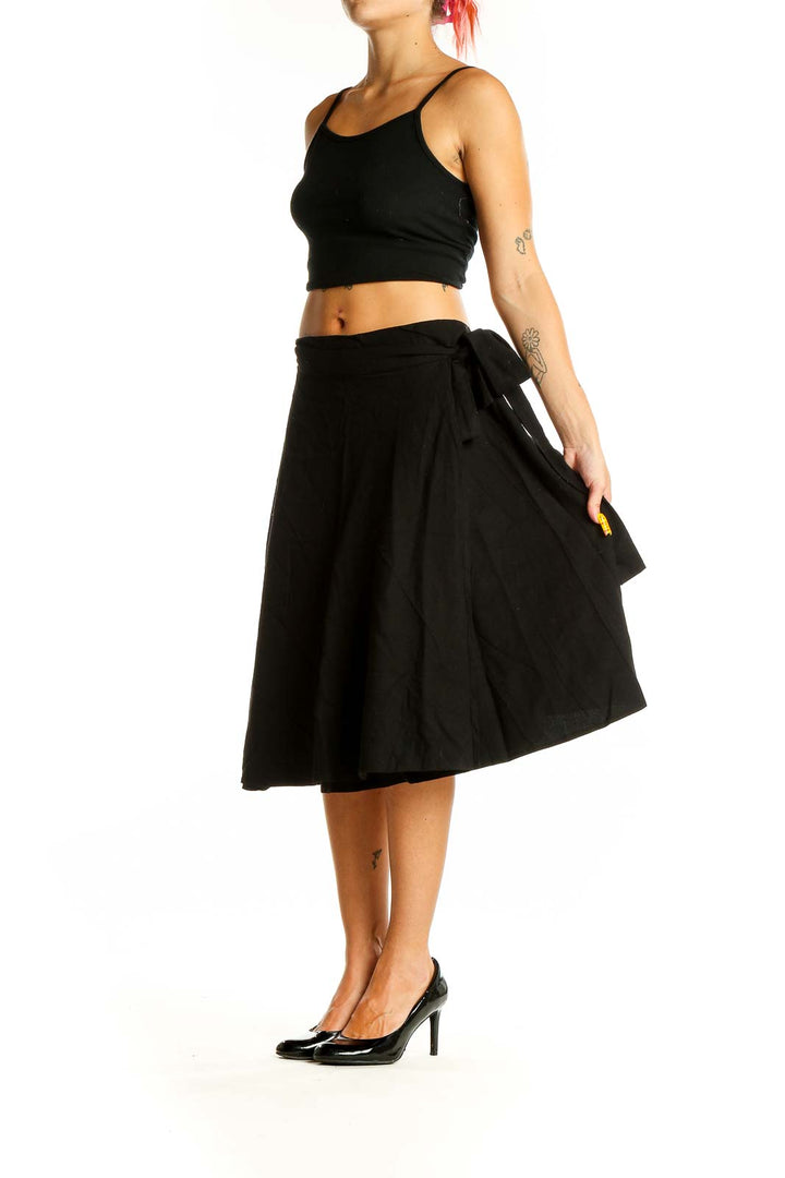 Front view of black A-line midi skirt with tie waist detail