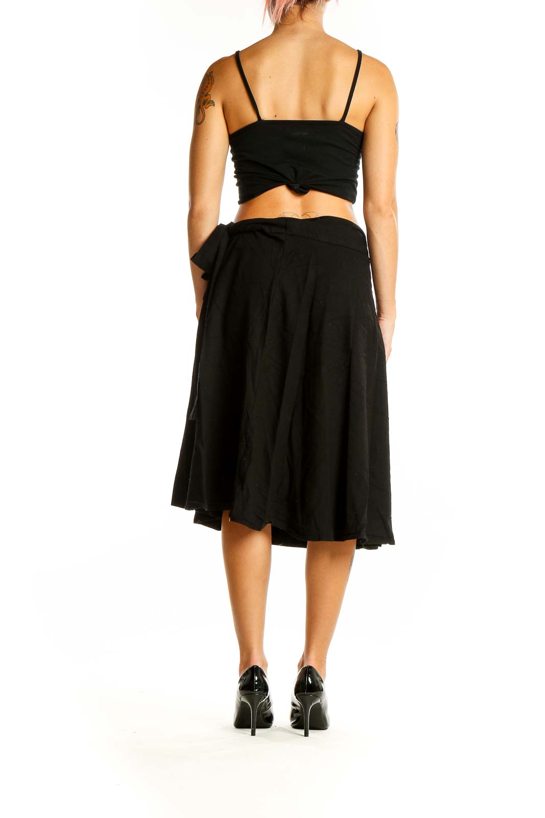 Back view of black A-line midi skirt on model