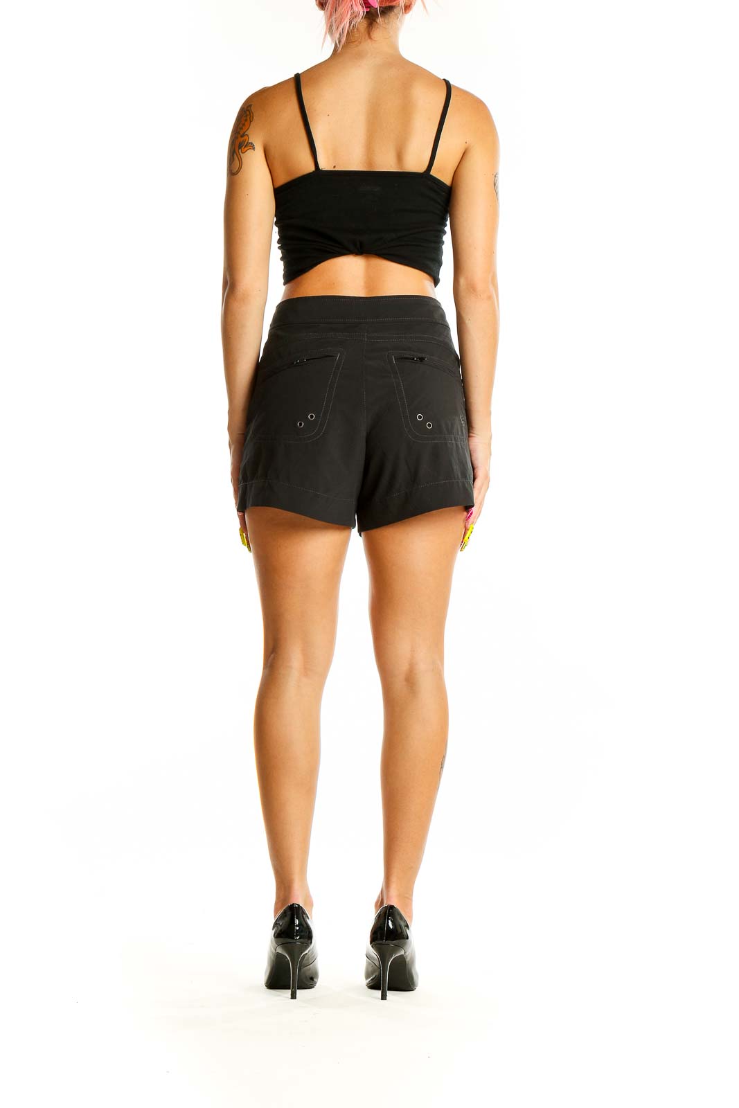 Back view of black Athleta activewear shorts showing grommet details