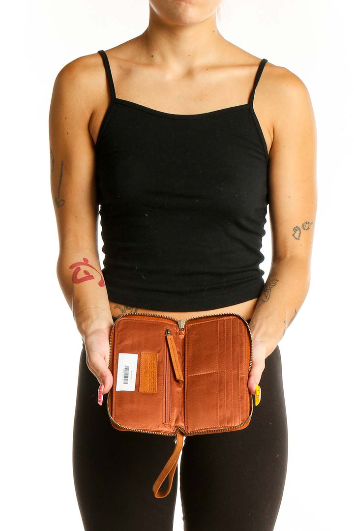 Open view of tan leather zip-around wallet clutch from Free People showing interior compartments