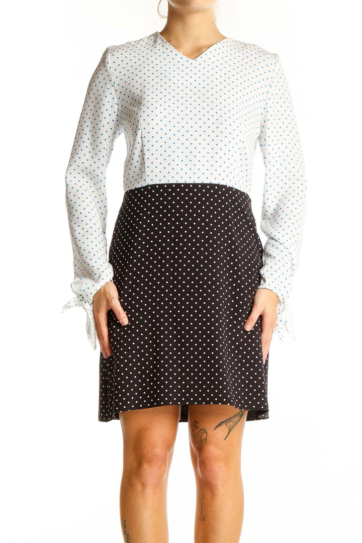 Front view of JW Anderson white and black polka dot contrast dress with long sleeves