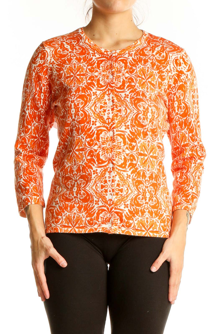 Front view of Sarah Spencer orange floral print long sleeve knit top