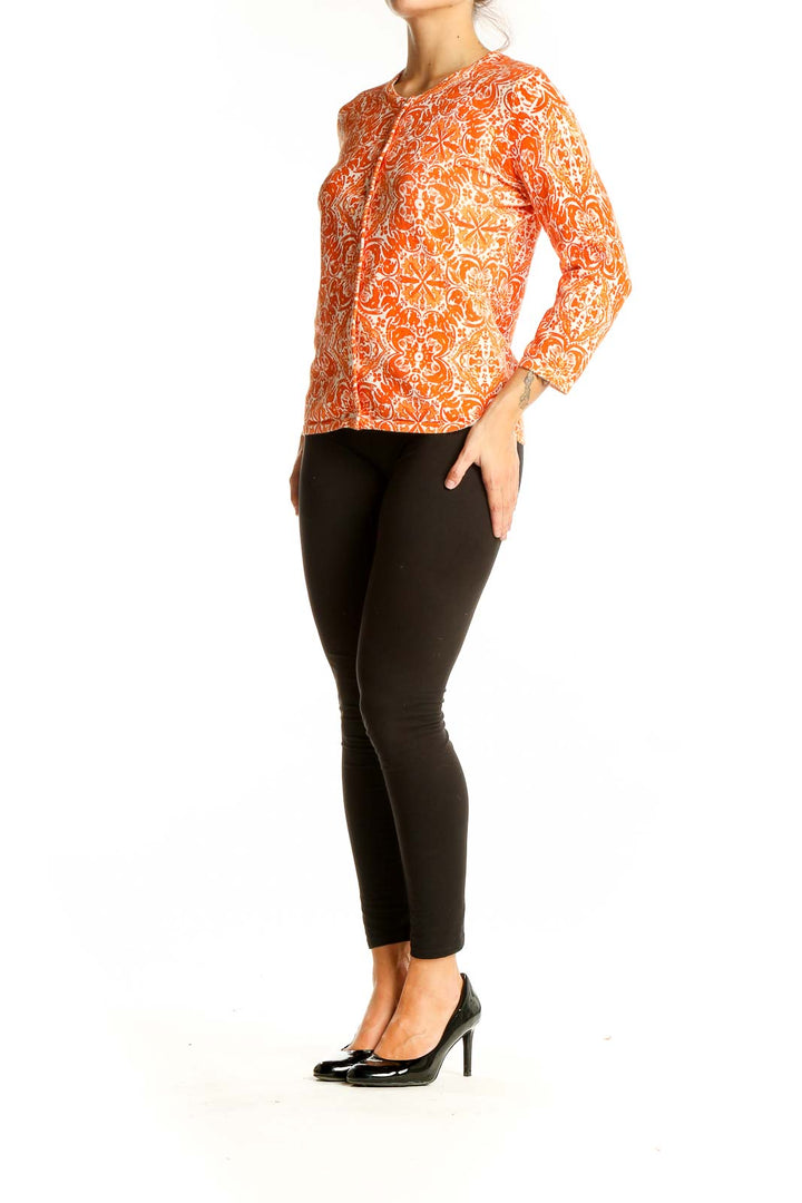 Front view of Sarah Spencer orange floral print long sleeve knit top