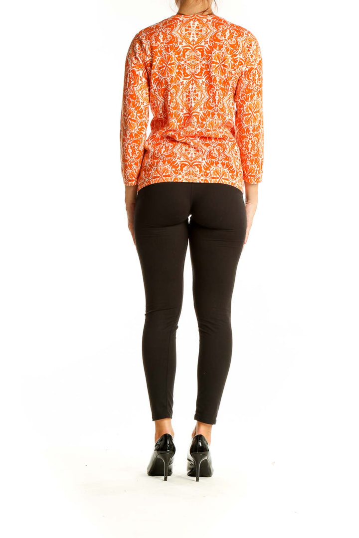 Back view of Sarah Spencer orange floral print long sleeve knit top