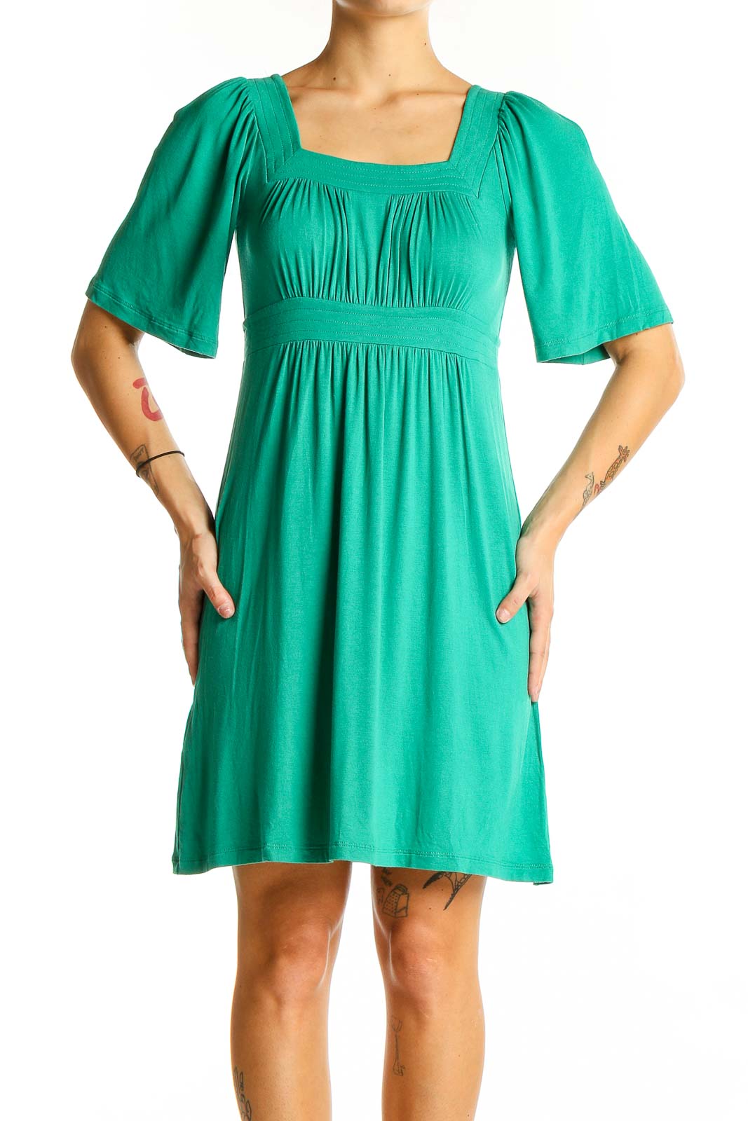 Front view of green BCBG MaxAzria dress with square neckline and empire waist