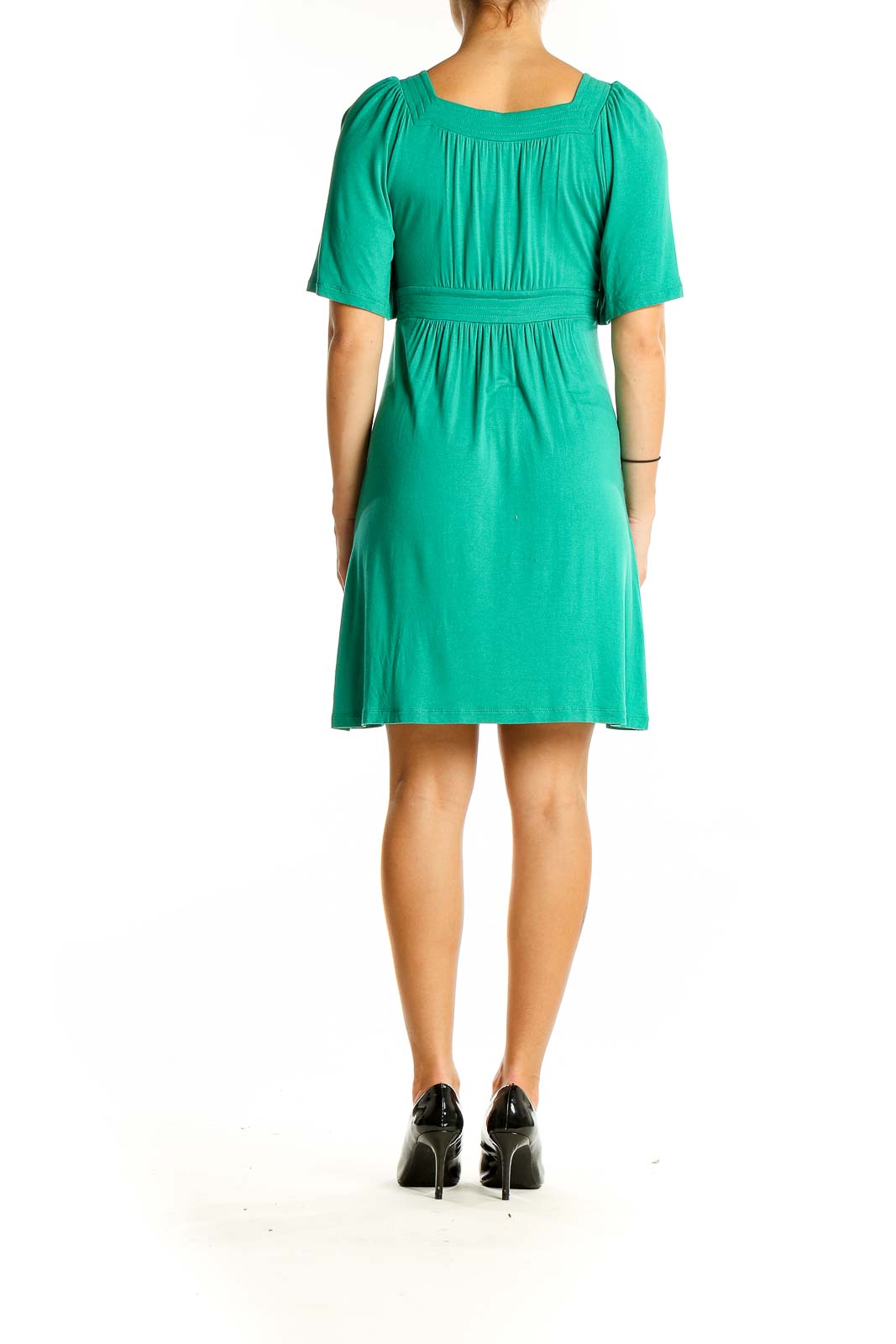 Back view of green BCBG MaxAzria dress showing flowy design and short sleeves