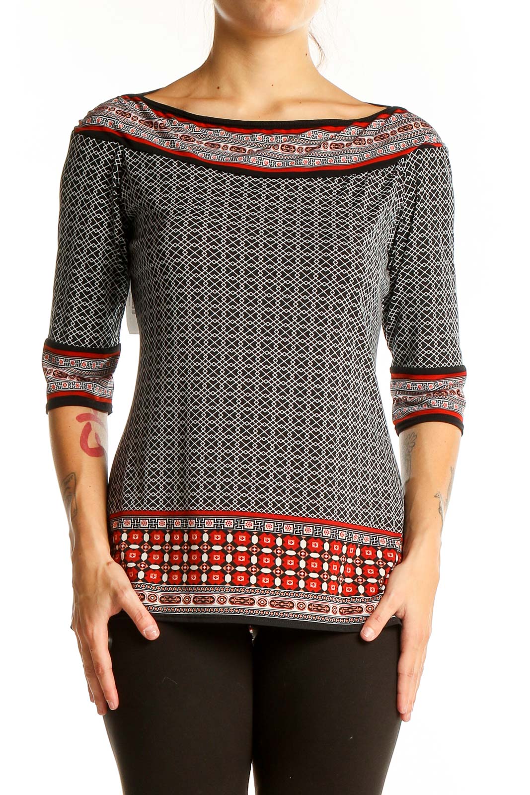 Front view of Max Studio black and white geometric print boatneck top with red accents