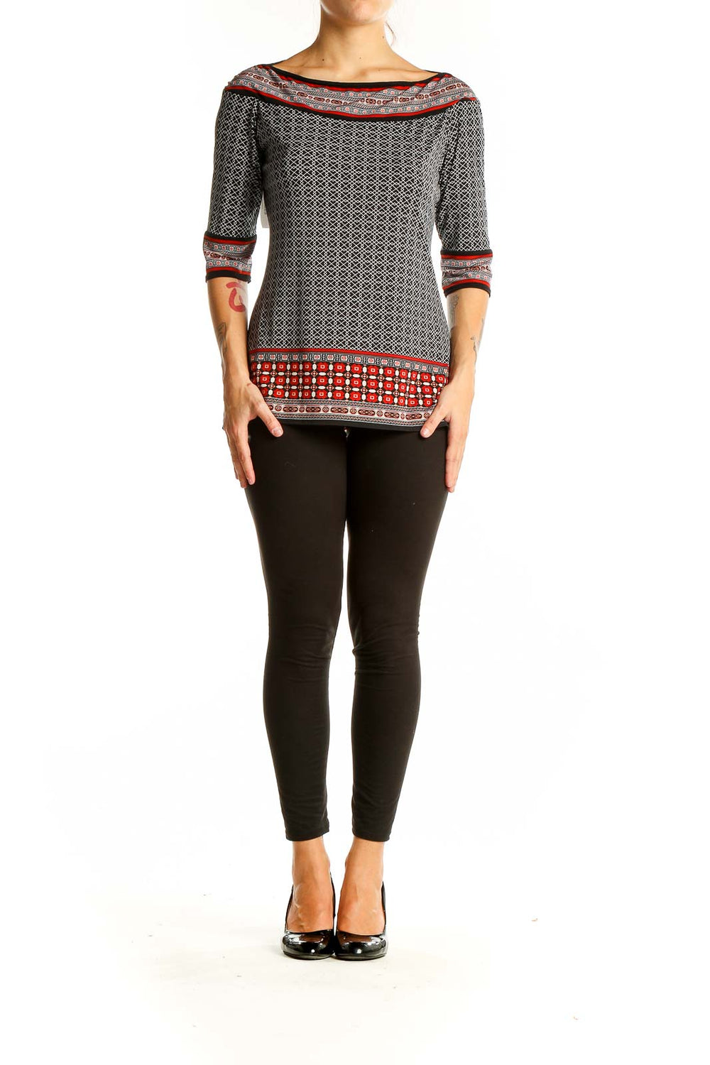 Front view of Max Studio black and white geometric print boatneck top with red accents