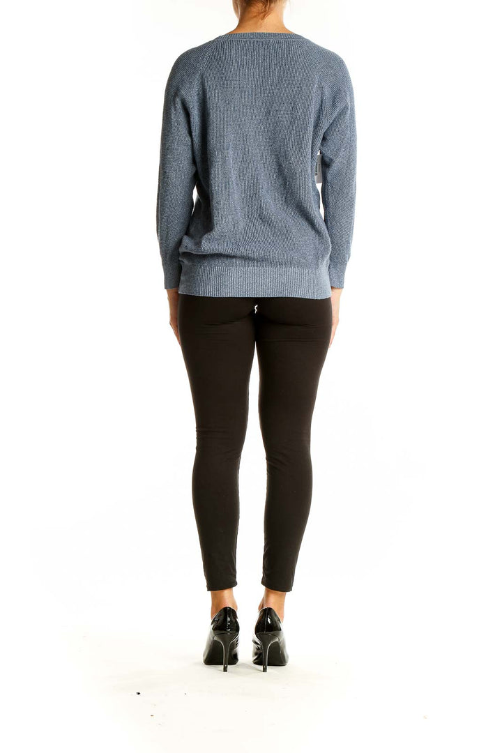 Back view of Madewell blue cotton knit sweater on model with black pants