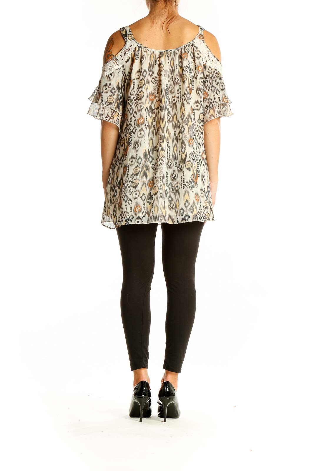 Back view of Daniel Rainn beige ikat print cold shoulder blouse showing flowy silhouette