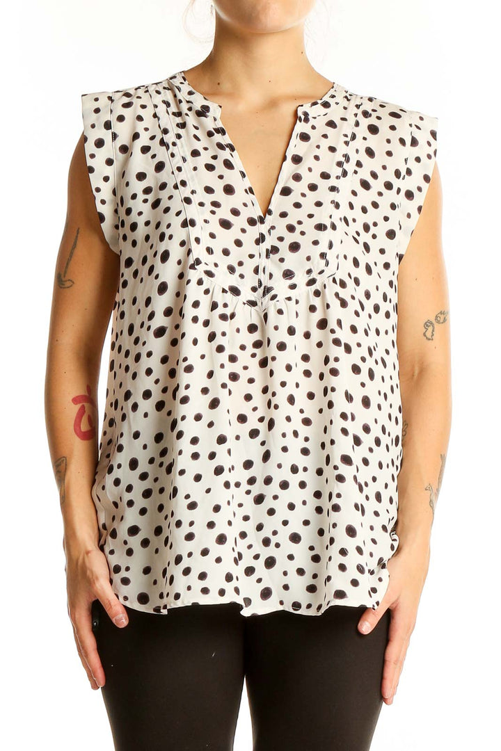 Front view of LOFT white sleeveless blouse with black polka dots and V-neckline