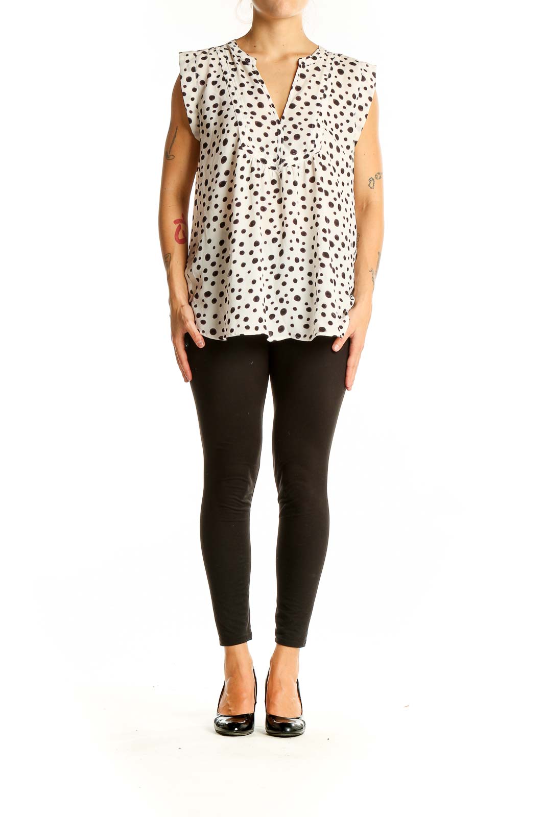 Front view of LOFT white sleeveless blouse with black polka dots and V-neckline