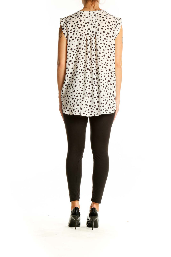 Back view of LOFT white sleeveless blouse with black polka dots showing relaxed fit