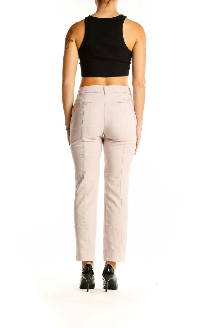 Back view of Express blush slim fit ankle pants on model