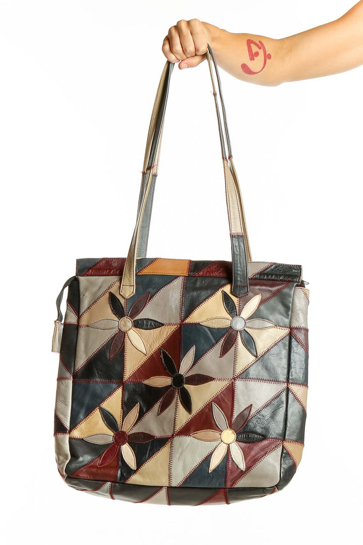 Front view of SilkRoll multicolor patchwork leather tote bag with geometric flower design