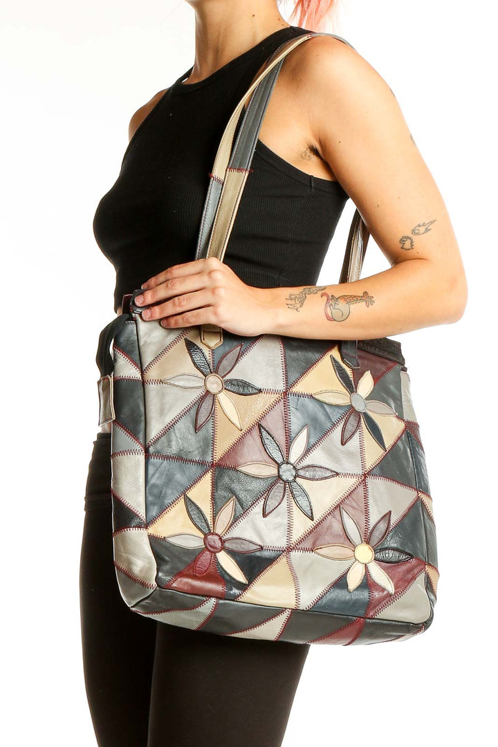 Front view of SilkRoll multicolor patchwork leather tote bag with geometric flower design