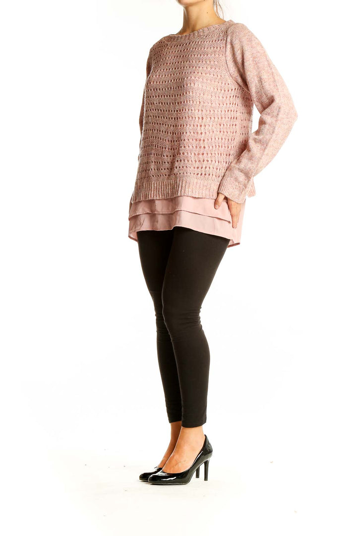 Front view of pink layered knit sweater with open-knit design