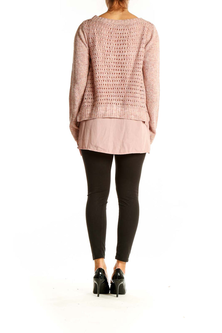 Back view of pink layered knit sweater showing open-knit pattern