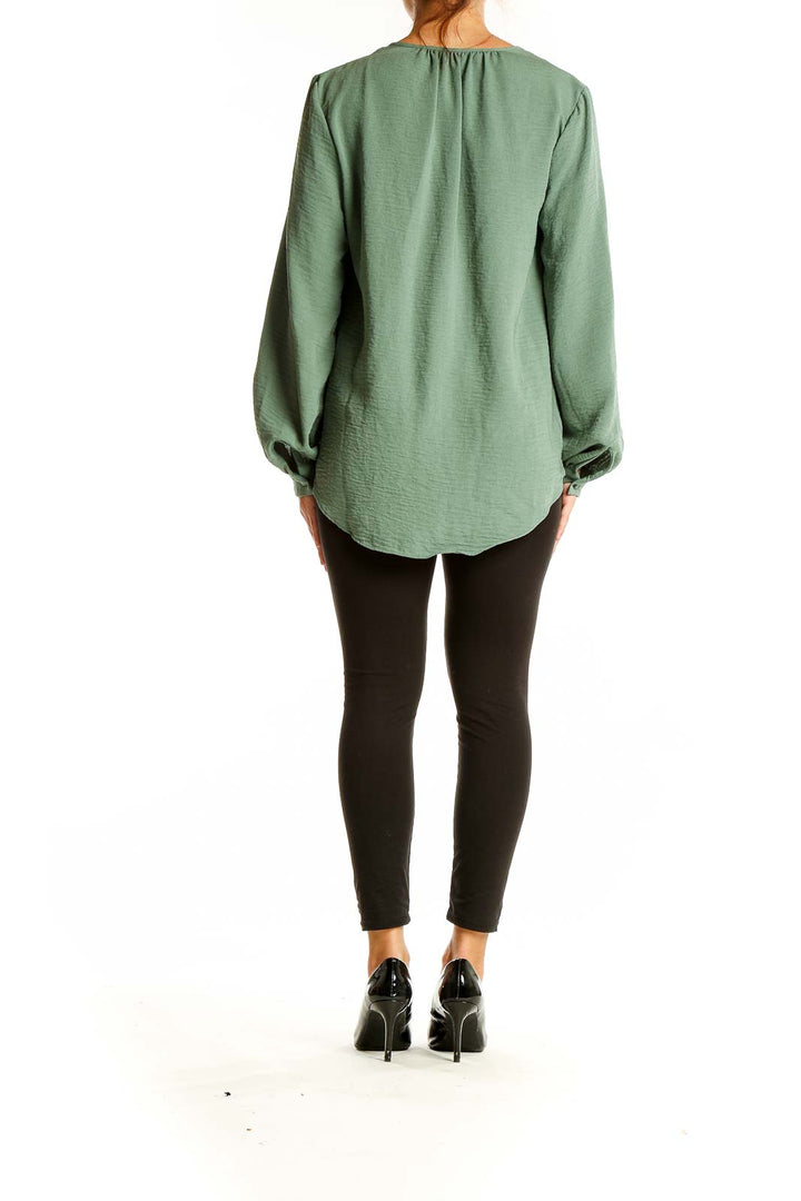 Back view of Nine West sage green blouse showing relaxed fit and balloon sleeves