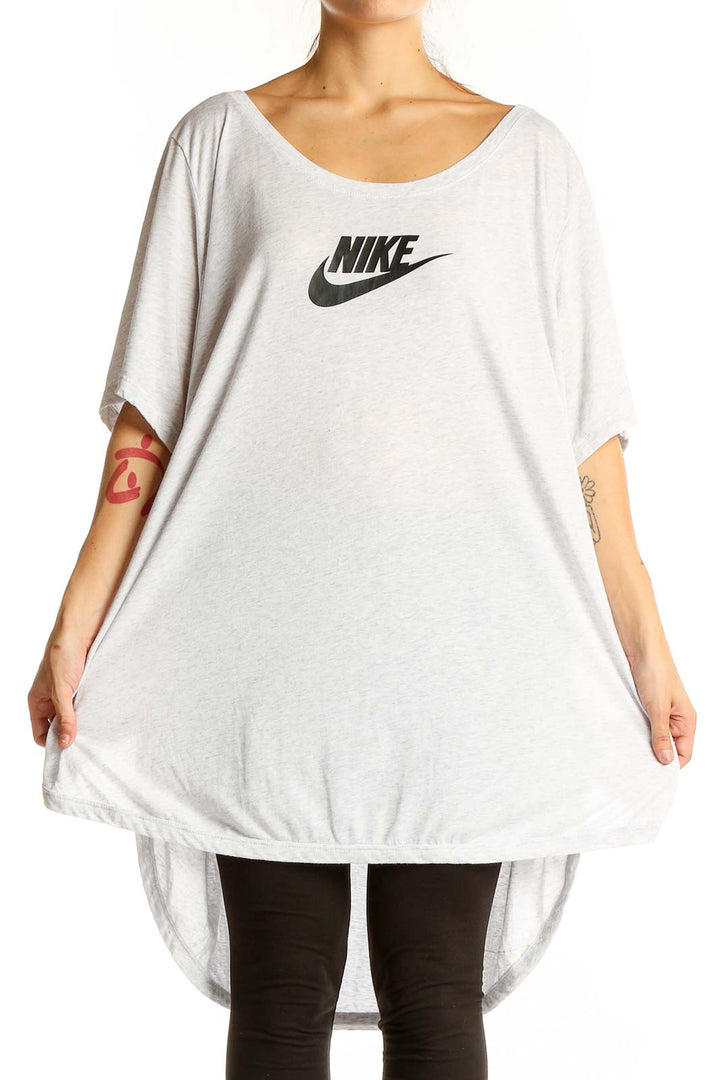 Front view of white oversized Nike logo t-shirt on model