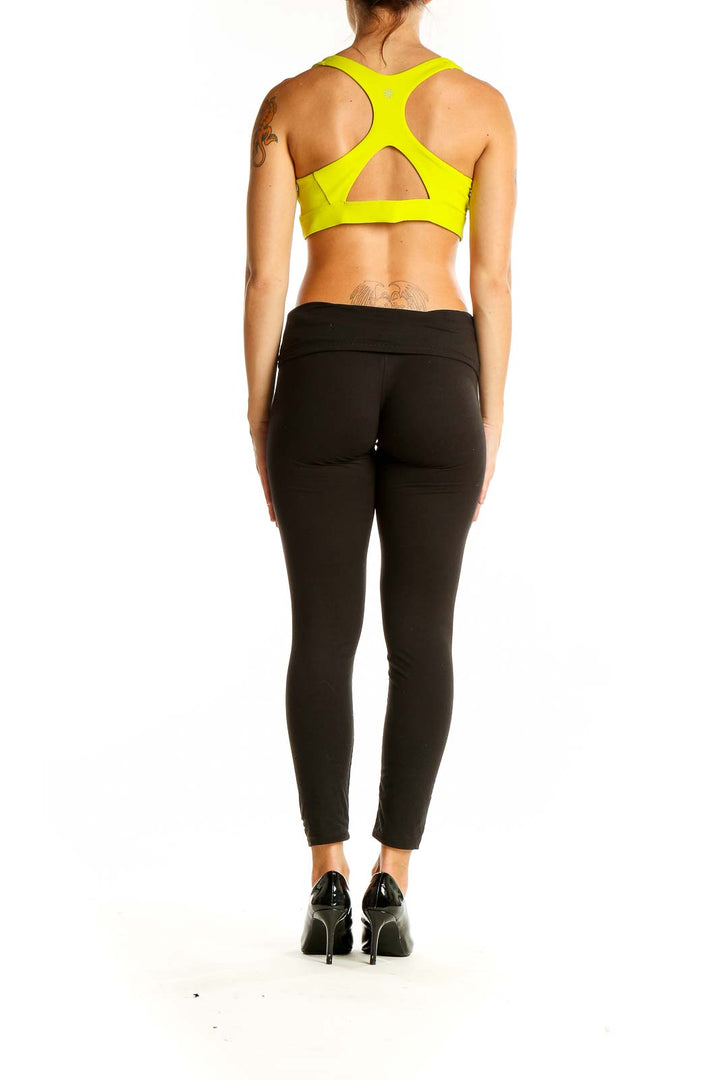 Back view of neon yellow Athleta sports bra with cutout detail