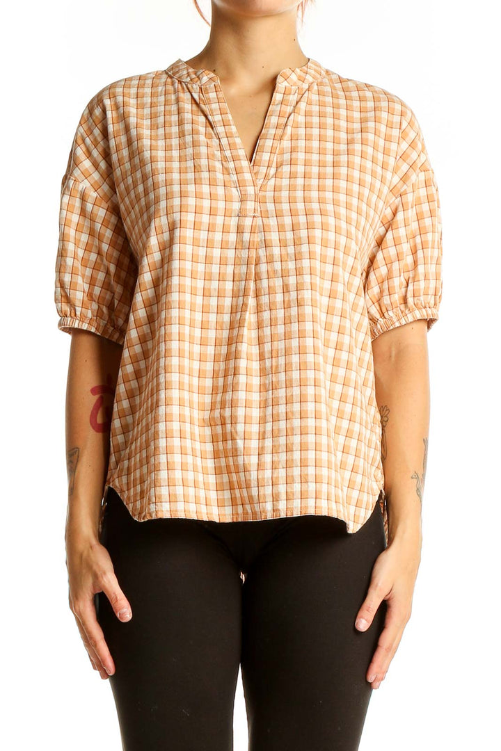 Front view of orange plaid Madewell cotton top with puff sleeves