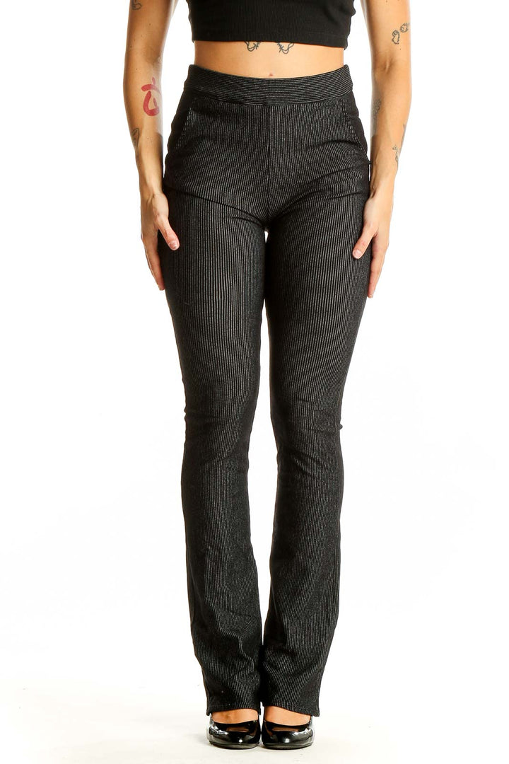 Front view of Studio M black ribbed flare pants on model