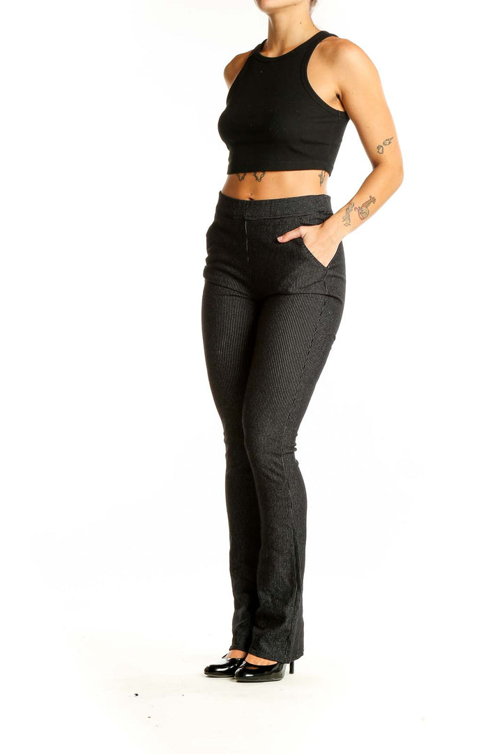 Front view of Studio M black ribbed flare pants on model