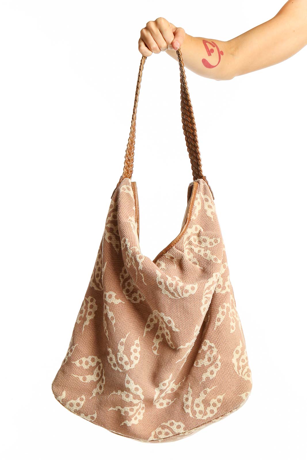 Front view of French Connection beige butterfly print hobo bag with braided straps