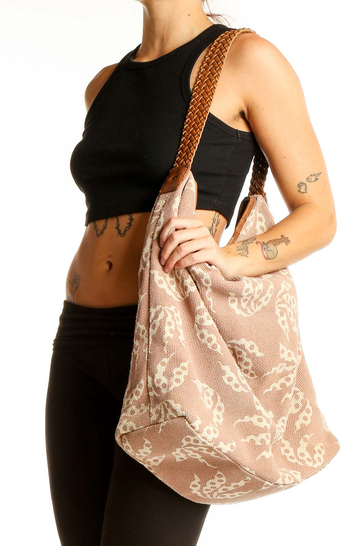 Front view of French Connection beige butterfly print hobo bag with braided straps