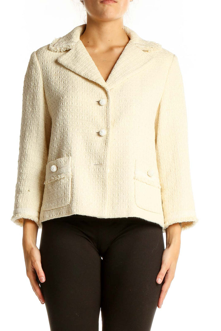 Front view of cream textured Ann Taylor blazer with notched collar and patch pockets