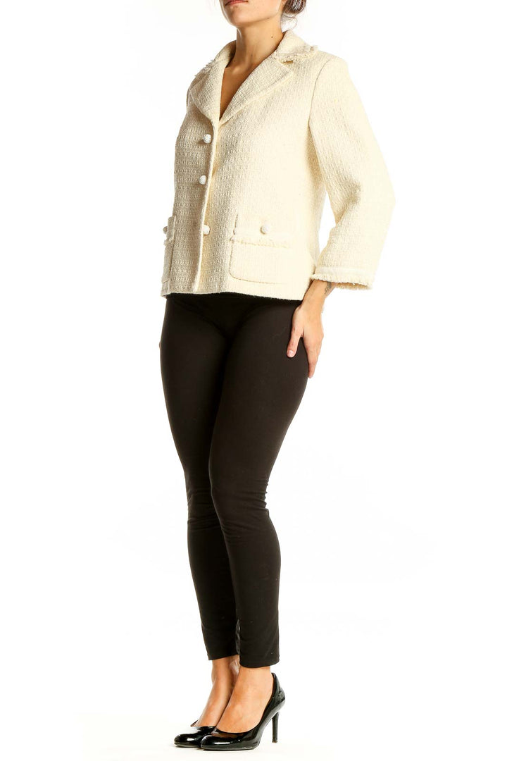 Front view of cream textured Ann Taylor blazer with notched collar and patch pockets