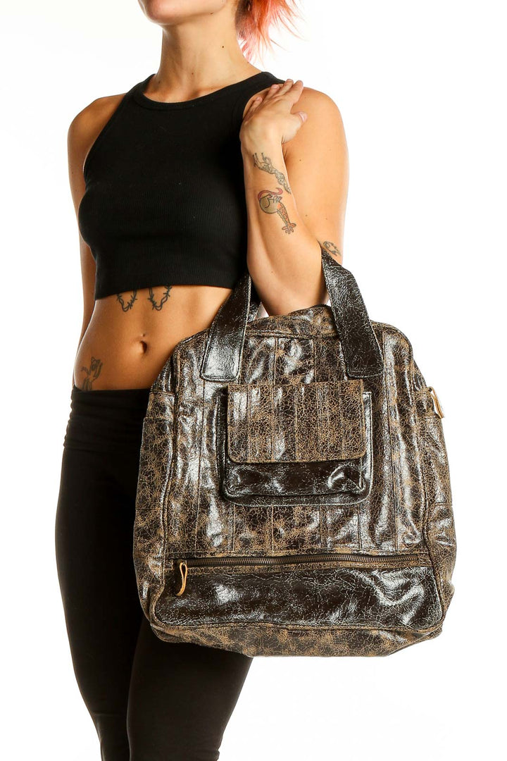 Front view of Bryna Nicole brown distressed leather satchel with top handles