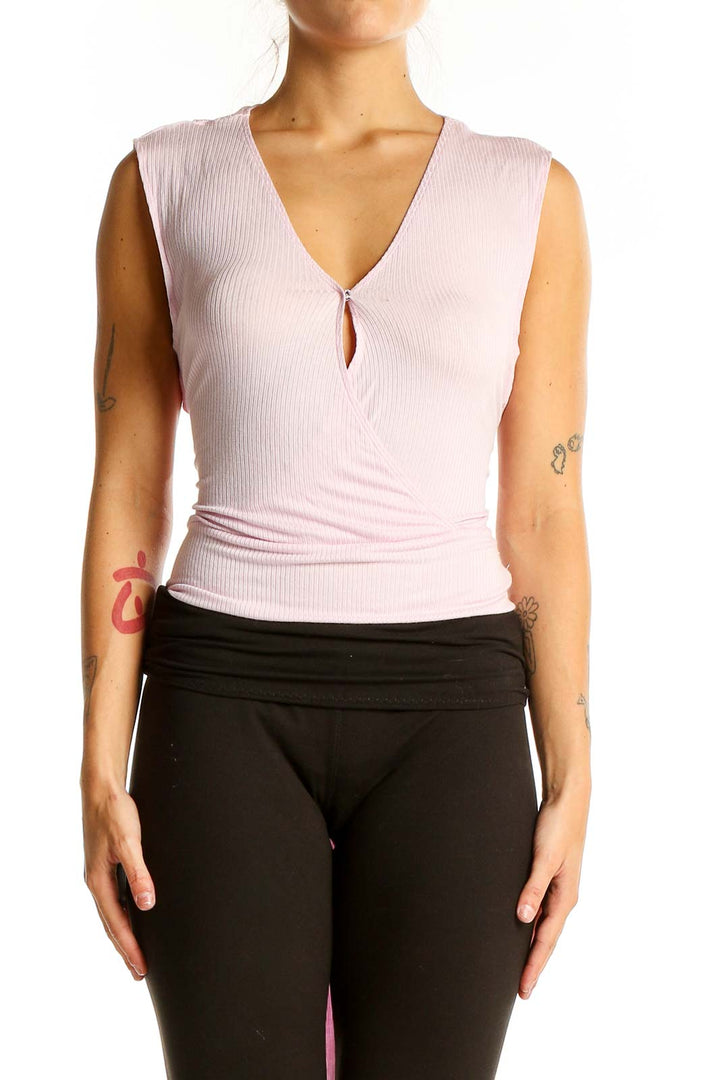 Front view of pink BCBGeneration sleeveless wrap-style top