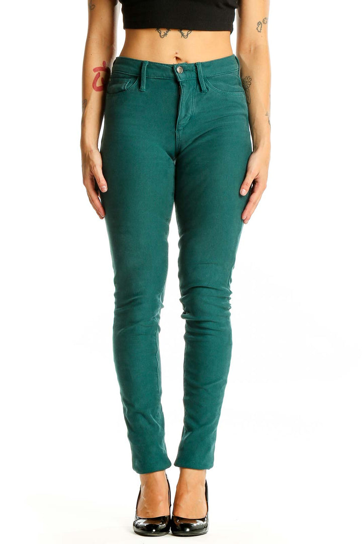 Front view of Joe's green skinny jeans on model