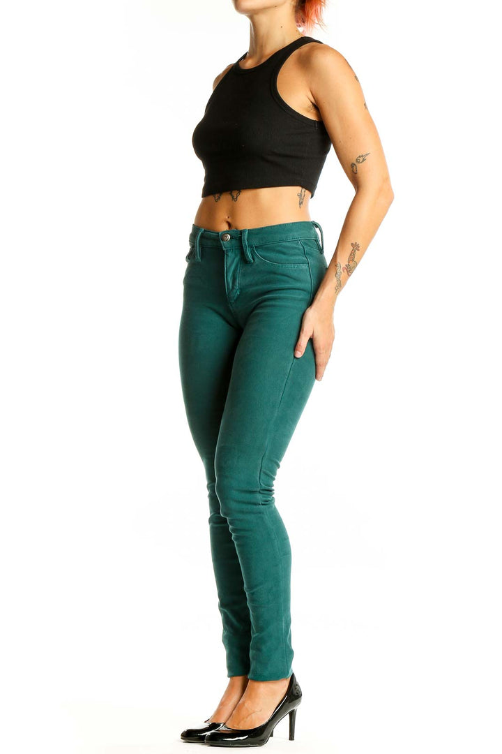 Front view of Joe's green skinny jeans on model