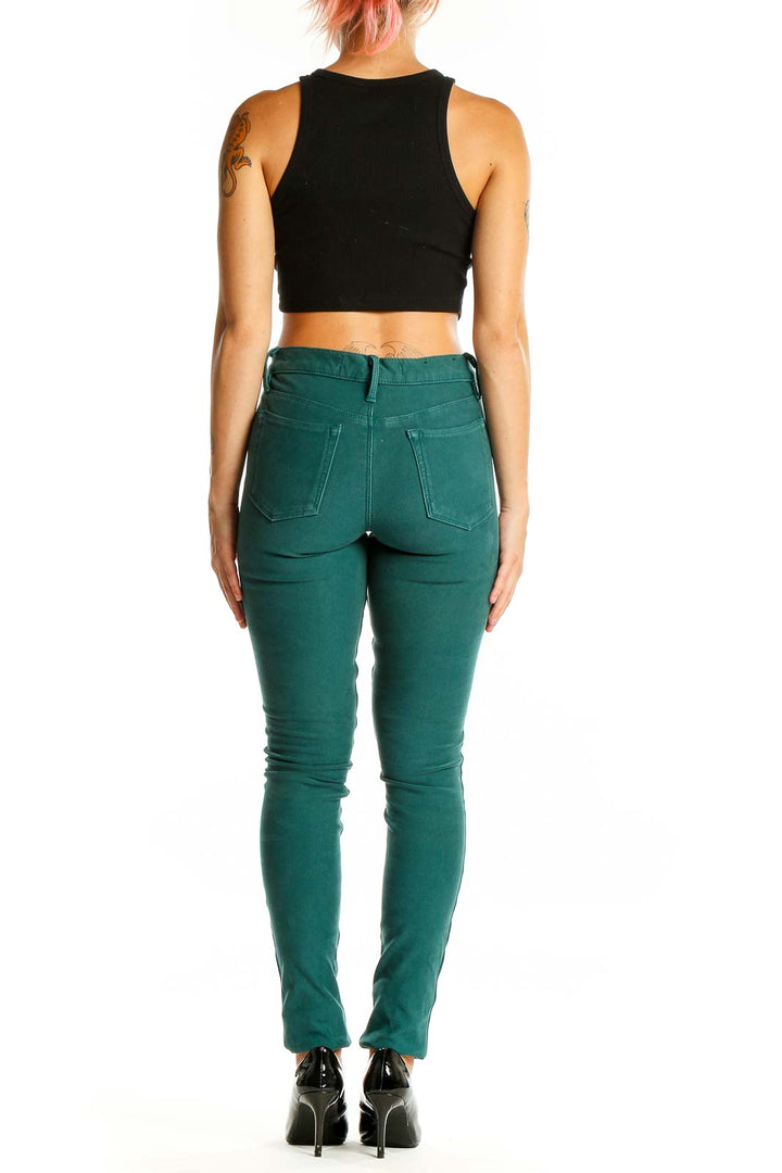 Back view of Joe's green skinny jeans on model