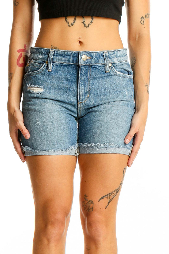 Front view of Joe's light blue distressed denim shorts on model