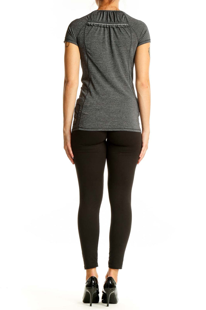 Back view of gray Lululemon performance top showing fitted silhouette