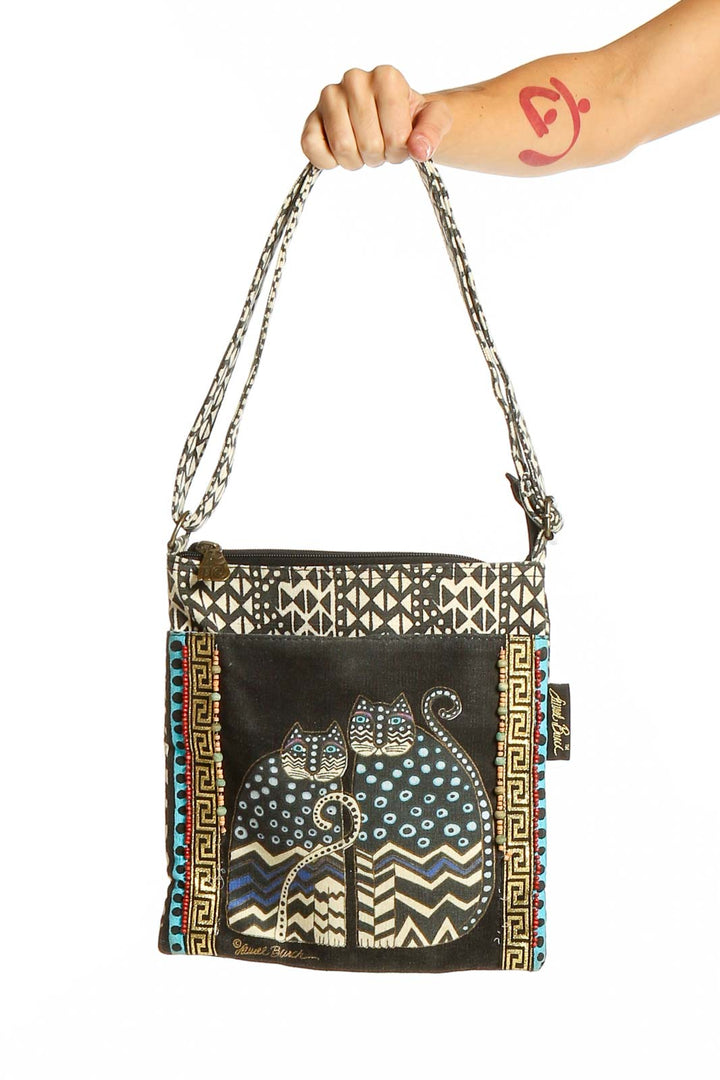 Front view of Laurel Burch black and white patterned cat shoulder bag with chain straps